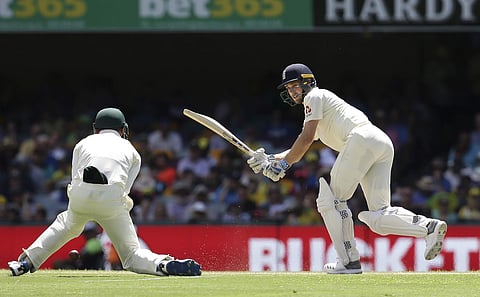 England's Chris Woakes plays a shot past Australia's Cameron Bancroft, left, during the Ashes cricket test between England and Australia in Brisbane, Australia, Sunday, Nov. 26, 2017. | AP