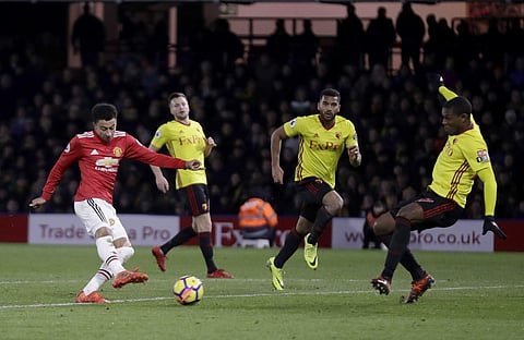 Manchester United's Jesse Lingard, left, scores his side's fourth goal during the English Premier League soccer match between Watford and Manchester United at Vicarage Road stadium in Watford, England, Tuesday. | AP