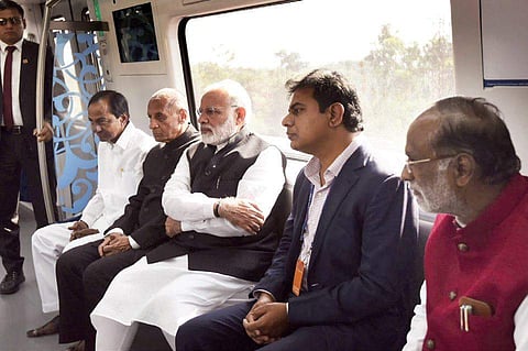 PM Narendra Modi taking a ride along with Governor ESL Narasimhan, CM K Chandrasekhar Rao and minister KTR;