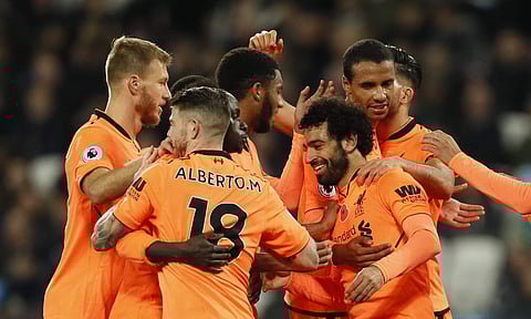 Liverpool's Mohamed Salah celebrates with teammates after scoring his side's fourth goal | AP