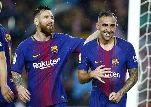 FC Barcelona's Paco Alcacer, right, celebrates after scoring with his teammate Lionel Messi during the Spanish La Liga soccer match between FC Barcelona and Sevilla at the Camp Nou stadium in Barcelona, Spain, Saturday, Nov. 4, 2017. | AP