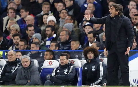 Manchester United head coach Jose Mourinho , left, watches as Chelsea's team manager Antonio Conte gestures during the English Premier League soccer match between Chelsea and Manchester United. | AP
