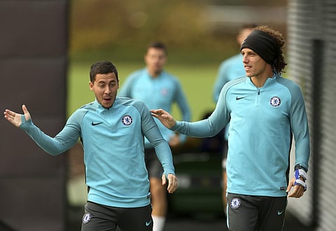 Chelsea's Eden Hazard, left, and David Luiz react at Chelsea's the training ground, in London Tuesday Oct. 17, 2017. | AP