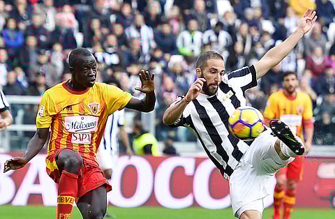 Juventus' Gonzalo Higuain, right, scores a goal during the Italian Serie A soccer match between Juventus and Benevento at the Allianz Stadium in Turin, Italy, Sunday, Nov. 5 2017. | AP