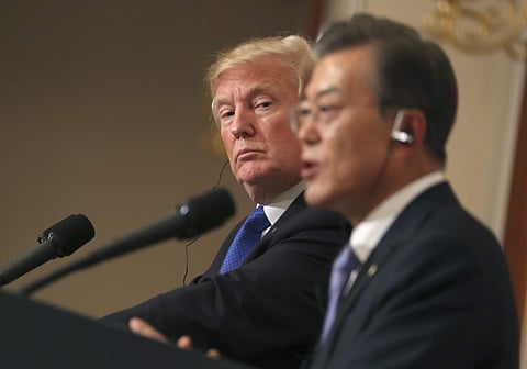 US President Donald Trump, left, listens to South Korean President Moon Jae-in during a joint news conference at the Blue House in Seoul | AP