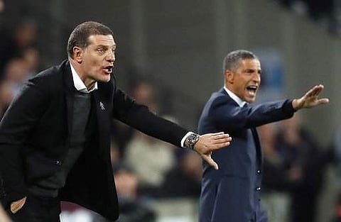 West Ham's head coach Slaven Bilic, left, and Brighton's team manager Chris Hughton gesture during the English Premier League soccer match between West Ham and Brighton and Hove Albion. | AP