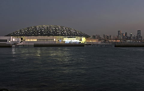 The night view of Louvre Abhu Dhabi is seen in front of the city skyline in Abu Dhabi, UAE | AP