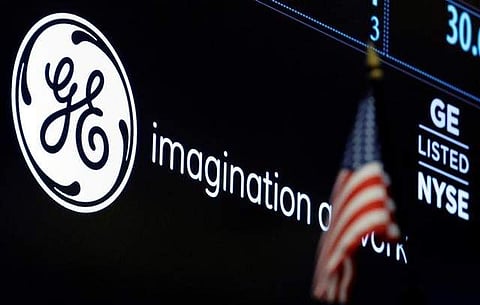 The ticker and logo for General Electric Co. is displayed on a screen at the post where it's traded on the floor of the NYSE. (Photo | Reuters)