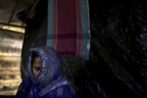 In this Monday, Nov. 20, 2017, photo, M, 35, mother of three, who says she was raped by members of Myanmar's armed forces in late August, is photographed in her friend's tent in Kutupalong refugee camp in Bangladesh. (Associated Press)