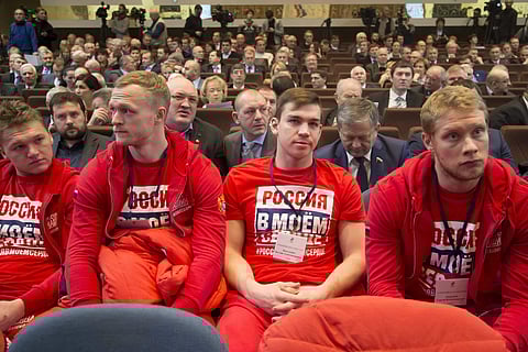 Russian ice hockey players with the words 'Russian is in my heart' on their sweatshirts attend an Russian Olympic committee meeting in Moscow | AP