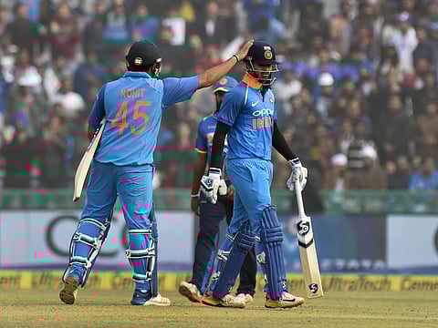 Indian skipper Rohit Sharma pats Shreyas Iyer for his innings as he walks off the field after his dismissal during the second ODI cricket match against Sri Lanka in Mohali. |PTI