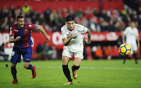Sevilla's Argentinian midfielder Joaquin Correa (R) runs for the ball with Levante's Spanish defender Pedro Lopez during the Spanish league football match Sevilla FC vs Levante at the Ramon Sanchez Pizjuan stadium in Sevilla on December 15, 2017. (AFP)
