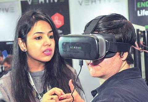 Delegates check out VR experience at stalls during TECH conference in Visakhapatnam on Saturday | Express