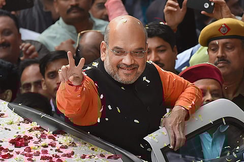 BJP President Amit Shah gestures while being welcomed on his arrival at the party headquarters in New Delhi on Monday after the party's victory in the Assembly elections in Gujarat and Himachal Pradesh. (Photo | PTI)