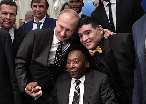 Russian President Vladimir Putin, left, Brazilian soccer legend Pele, center, and Argentinian soccer legend Diego Armando Maradona pose for a photo prior to the 2018 soccer World Cup draw in the Kremlin in Moscow. | AP