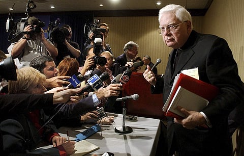 A file photo of Cardinal Bernard Law, right, departs a news conference during the second day of the U.S. Conference of Catholic Bishops annual meeting in Washington. (Photo | AP)