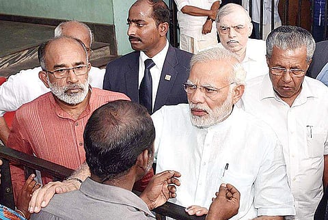 Prime Minister Narendra Modi listens to family members of dead and missing fishermen at Poonthura on Tuesday. Union Minister of State for Tourism Alphons Kannanthanam, Governor P Sathasivam and Chief Minister Pinarayi Vijayan are also seen | PRD Photo