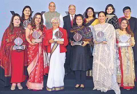 Holding their Devi trophies, the winners pose with Union Home Minister Rajnath Singh and The New Indian Express Editorial Director Prabhu Chawla