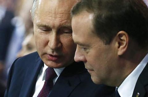 Russian President Vladimir Putin, left, speaks to Prime Minister Dmitry Medvedev during the United Russia party congress in Moscow, Russia, Saturday, Dec. 23, 2017. | AP