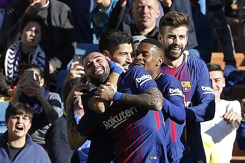 Barcelona's Aleix Vidal, left, celebrates after scoring his team's 3rd goal during a Spanish La Liga soccer match between Real Madrid and Barcelona at the Santiago Bernabeu stadium in Madrid, Spain, Saturday, Dec. 23, 2017. | AP