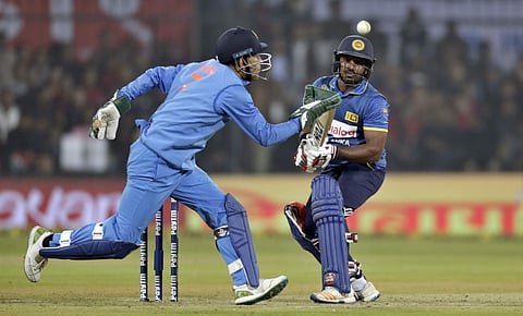 India's wicket-keeper MS Dhoni runs to catch the ball played by Kusal Perera | AP