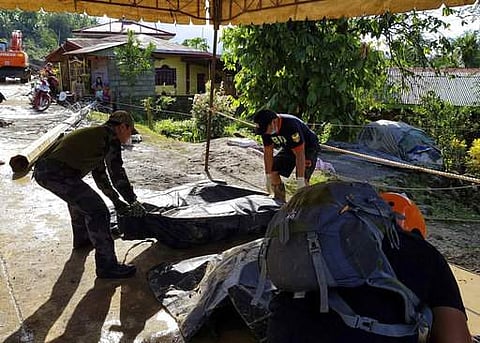 A slow-moving storm has left dozens of people dead and several others missing mostly due to landslides and floods and stranded thousands of holiday travelers in the central Philippines. | AP