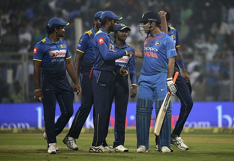 India's Mahindra Singh Dhoni interacts with Sri Lankan players at the end of their third T20 international match in Mumbai, India, Sunday, Dec. 24, 2017. | AP