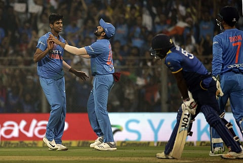 India's Washington Sundar celebrates with captain Rohit Sharma after the dismissal of Sri Lanka's Kusal Perera during their third and final T20 match in Mumbai, India, Sunday, Dec. 24, 2017. | AP