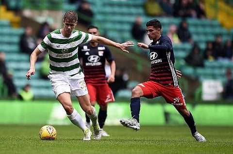 Lyon's forward Houssem Aouar (R) vies with Celtic's defender Kristoffer Ajer during a football match between Glasgow Celtic and Olympique Lyonnais at Celtic Park in Glasgow. (File | AFP)