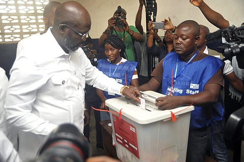 Former soccer star George Weah, Presidential candidate for the Coalition for Democratic Change, casts his vote during a Presidential runoff election in Monrovia, Liberia, Tuesday Dec. 26, 2017. | AP