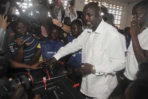 George Weah, presidential candidate for the Coalition for Democratic Change, casts his vote