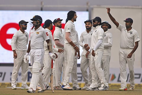 Indian cricket players celebrate the dismissal of Sri Lanka's Dhananjaya De Silva during the second day of their third Test match in New Delhi, India, Sunday, Dec. 3, 2017. | AP