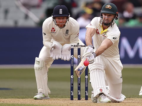 Australia's Shuan Marsh, right, attempts to sweep the ball in front of England's Jonny Bairstow during the second day of their Ashes Test match in Adelaide, Sunday, Dec. 3, 2017. | AP