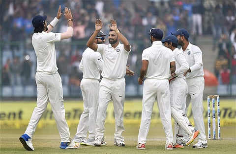 Indian bowler Mohammed Shami along with teammates celebrates the wicket of Sri Lanka's Dimuth Karunaratne during the second day of the third cricket test match at Feroz Shah Kotla. | PTI