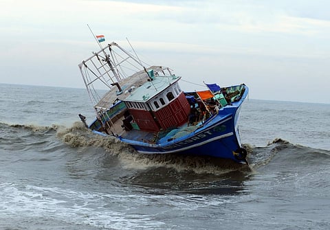 Rough sea at Puthiyappa Kozhikode, fishermen hanging on to the boat which lost control in the heavy winds and waves after Cyclone Ockhi hit off Puthiyappa coast in Kozhikode on Friday.(Photo: EPS/A Sanesh)