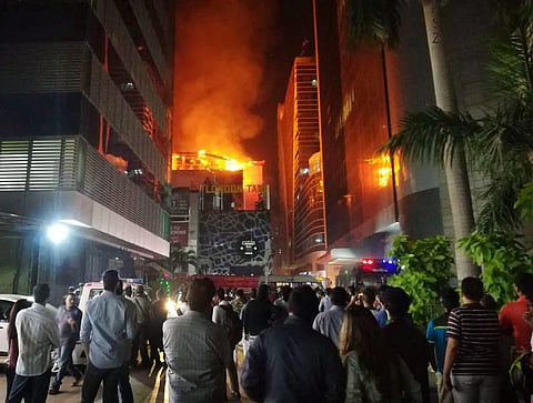 A view from the street after a fire broke out in a building in Mumbai on Friday. At least 14 people were killed and as many injured after a major fire in Kamala Mills Compound in Lower Parel. | PTI