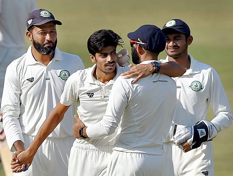 Vidarbha bowler Rajnish Gurbani celebrates his sixth wicket with his teammates during the second day of the Ranji Trophy final between Delhi and Vidarbha in Indore on Saturday. | PTI