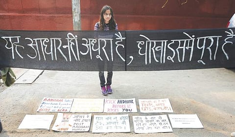 Eidya Pal protests against the mandatory linking of Aadhaar number with various services at ITO in New Delhi. (Express | Shekhar Yadav)