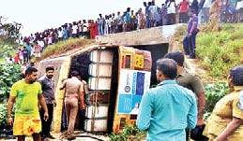 Locals gather at the site where government bus topple near Avinashi in Tirupur district on Sunday | Express