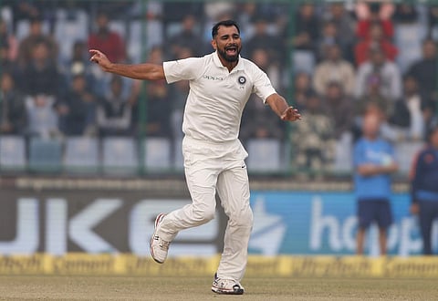 India's Mohammed Shami celebrate the dismissal of Sri Lanka's Dimuth Karunaratne during the second day of their third Test match in New Delhi, India, Sunday, Dec. 3, 2017. | AP