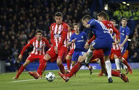 Chelsea's Eden Hazard makes a shot on goal, which Atletico's Stefan Savic made an own goal during the Champions League Group C soccer match between Chelsea and Atletico Madrid at Stamford Bridge stadium in London Tuesday, Dec. 5, 2017. | AP
