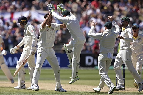 Australia's Mitchell Starc, second left, celebrates with teammates after taking the wicket of England's Craig Overton, left, during the fifth day of their Ashes Test match in Adelaide, Wednesday, Dec. 6, 2017. | AP