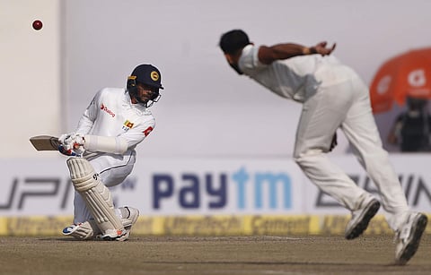 Sri Lanka's Dhananjaya De Silva, left, bends to avoid a rising delivery from India's Mohammed Shami, right, during the fifth day of their third Test match in New Delhi, India, Wednesday, Dec. 6, 2017. | AP