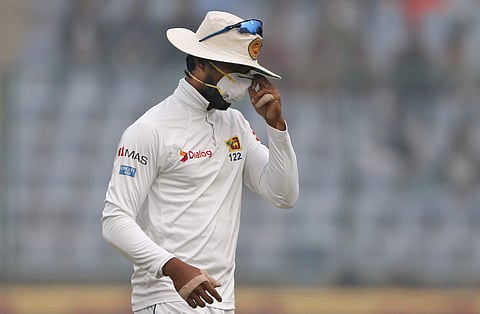 Sri Lanka's captain Dinesh Chandimal adjusts his anti-pollution mask during the New Delhi Test | AP