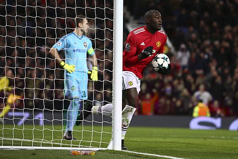 Manchester United's Romelu Lukaku celebrates after scoring his team first goal as CSKA's goalkeeper Igor Akinfeev, left, stands near the gates during the Champions League group A soccer match between Manchester United and CSKA Moscow in Manchester. | AP