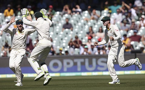 Australia's Steve Smith, left, Tim Paine and Peter Handscomb, right celebrate the fall of the last English wicket at the end of their Ashes Test match in Adelaide, Wednesday, Dec. 6, 2017. | AP