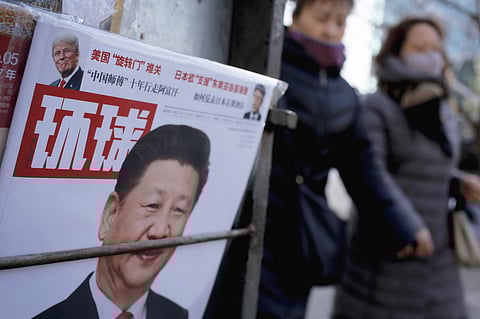 Women walk past a news stand displaying a Chinese news magazine fronting a photo of Chinese President Xi Jinping and U.S. President Donald Trump in Beijing, Thursday, Feb. 9, 2017. (File | AP)