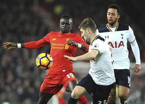 Liverpool's Sadio Mane, left, is challenged by Tottenham's Ben Davies, centre, and Tottenham's Mousa Dembele during the English Premier League soccer match between Liverpool and Tottenham Hotspur at Anfield. | AP