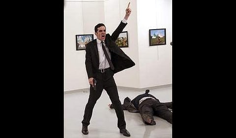 In this December 19, 2016 photo Mevlut Mert Altintas shouts after shooting Andrei Karlov, right, the Russian ambassador to Turkey, at an art gallery in Ankara, Turkey. (File Photo | AP)