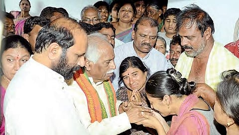 Union minister of state for labour and employment Bandaru Dattatreya consoles Vamshi’s parents at the youth’s native village Vangapad on Friday | express